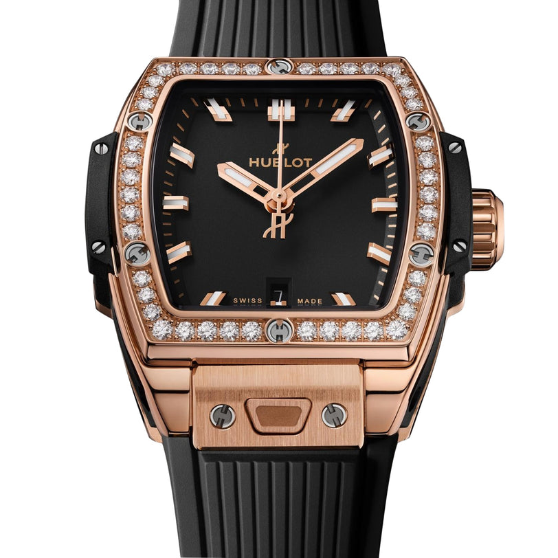 A Hublot Spirit Of Big Bang King Gold Diamonds watch in 18K gold with a diamond-set bezel, black dial, and black rubber strap shows the time as 10:10.
