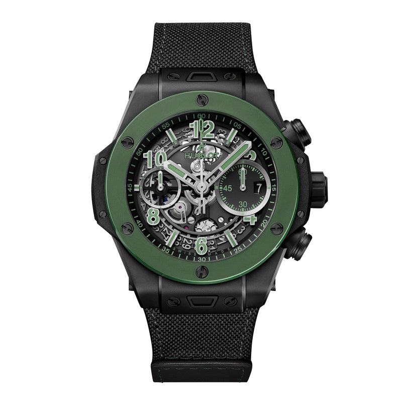 The Hublot Big Bang Unico The Watches of Switzerland Group Exclusive is a black and green chronograph wristwatch with a skeleton dial and black fabric strap, featuring detailed internal mechanics in a striking limited-edition design.