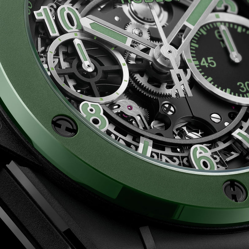 Close-up of the Hublot Big Bang Unico The Watches of Switzerland Group Exclusive, featuring a green bezel and skeleton dial with exposed gears and numerals, inspired by Hublots iconic Big Bang Unico design.