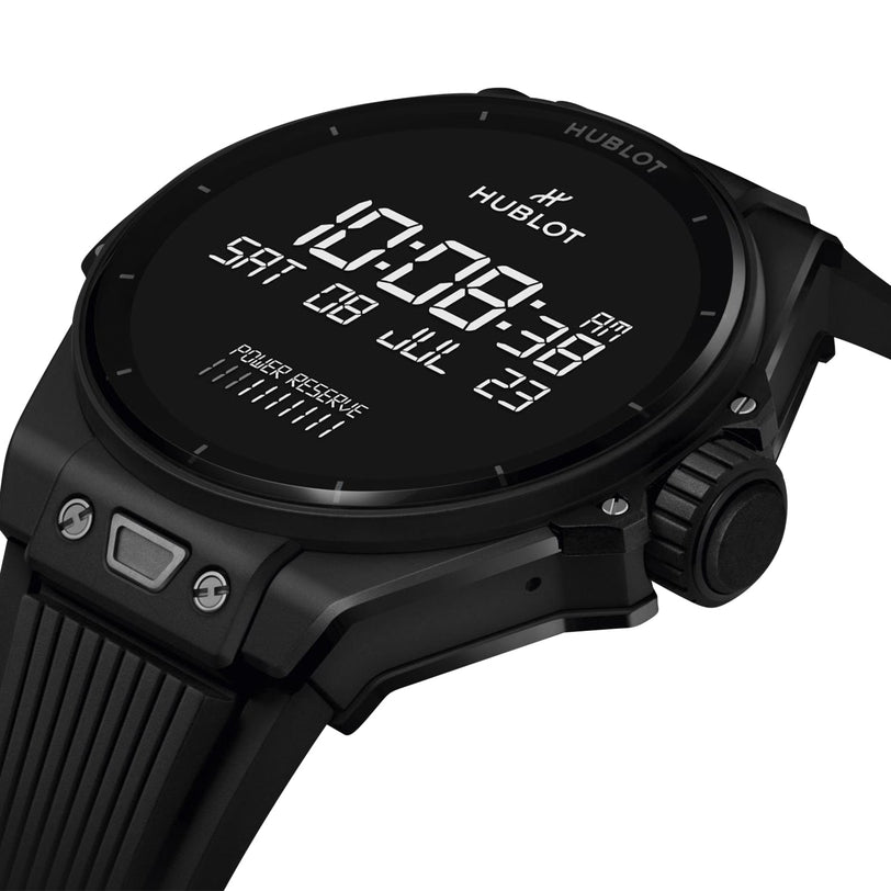 Close-up of the Hublot Big Bang E Gen3 Black Magic, a black digital smartwatch from the Big Bang collection, displaying time, date, power reserve, and more with advanced smart technology on its screen.