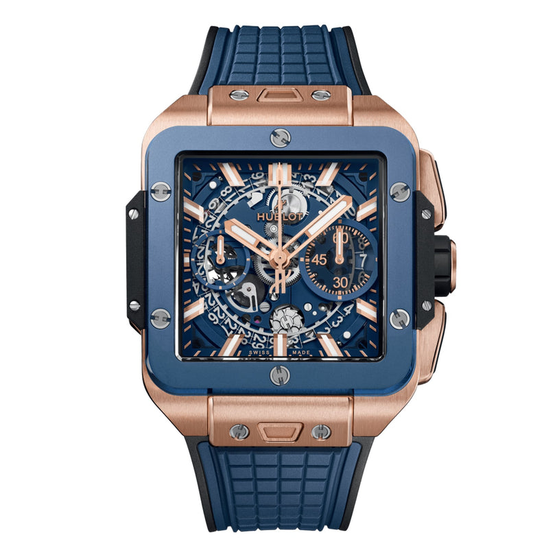 The Hublot Square Bang Unico King Gold Blue Ceramic is a luxury wristwatch with a blue and King Gold case, rubber strap, skeleton dial, and multiple subdials featuring a chronograph flyback function.
