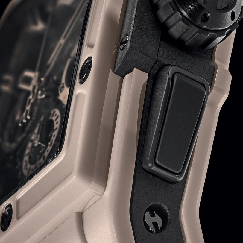 Close-up of the Hublot Spirit of Big Bang Beige Ceramic, featuring a beige and black high-tech ceramic case with visible crown, screws, and part of its transparent watch face.