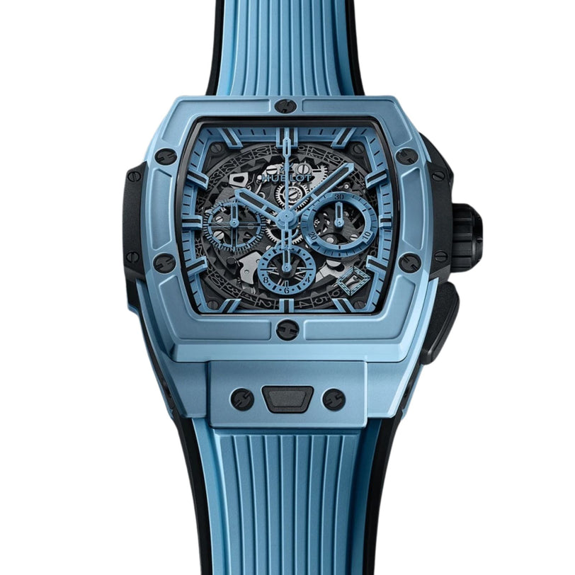 The Hublot Spirit of Big Bang Sky Blue Ceramic features a blue skeleton dial, rectangular case, visible gears, ribbed rubber strap, and advanced HUB4700 caliber with silicon regulating element, shown against a white background.
