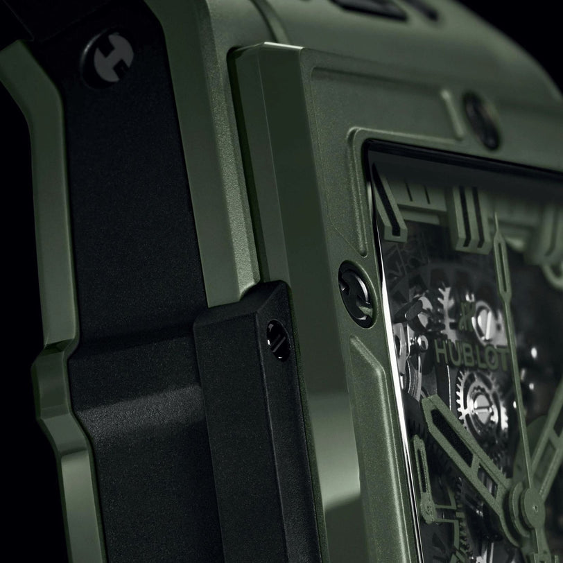 Close-up view of the Hublot Spirit of Big Bang Dark Green Ceramic wristwatch, showcasing its high-tech green ceramic case, visible screws, and partially revealed skeletonized movement with gears.