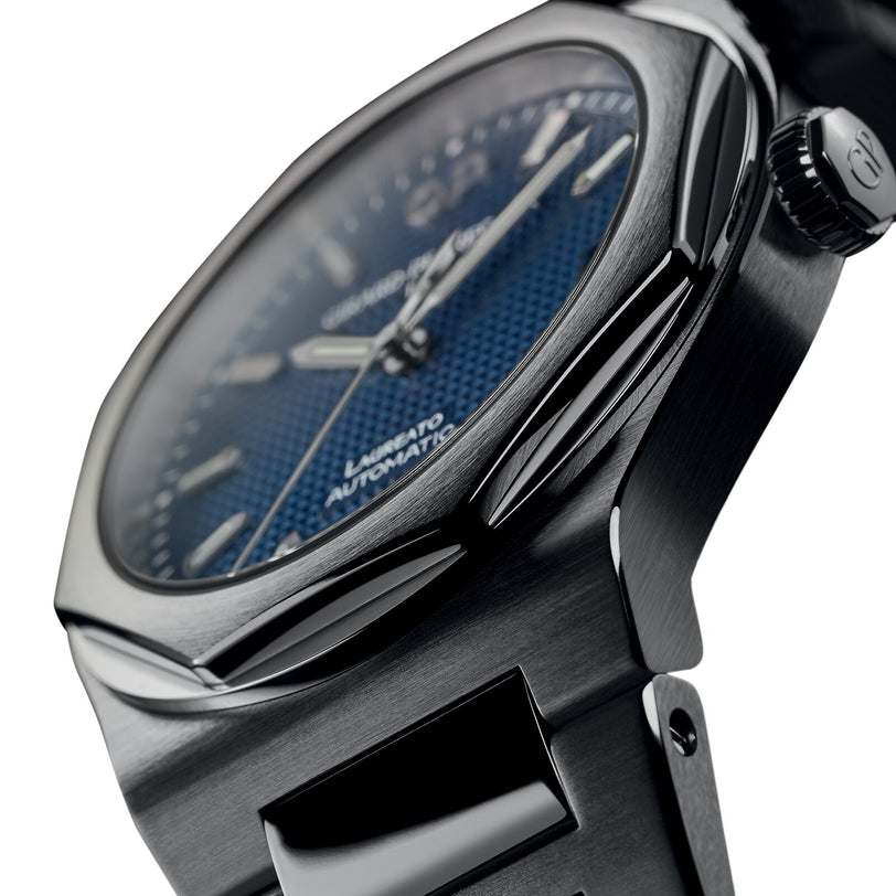 Close-up side view of the Girard-Perregaux Laureato 42 wristwatch with a stainless steel case, octagonal bezel, blue textured dial, silver hands, and Automatic text visible on the face.