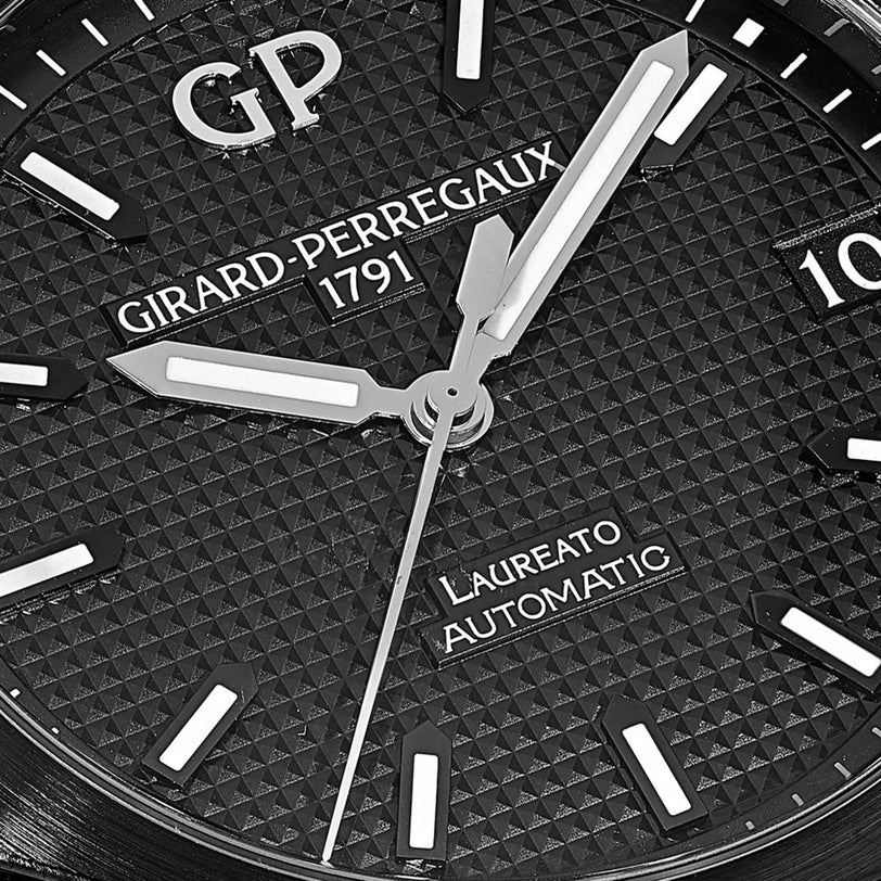 Close-up of the Girard-Perregaux Laureato 42 watch face at 10:08:35, showing a textured black dial, silver hands, and the signature octagonal bezel.