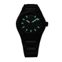 The Girard-Perregaux Laureato 42 is a black wristwatch with a dark face, glowing green hour markers and hands, and an octagonal bezel, shown against a plain white background.