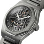 A close-up of the Girard-Perregaux Laureato Skeleton showcases visible gears, intricate mechanics, an octagonal bezel, stainless steel case and bracelet, plus the GP logo on the crown.