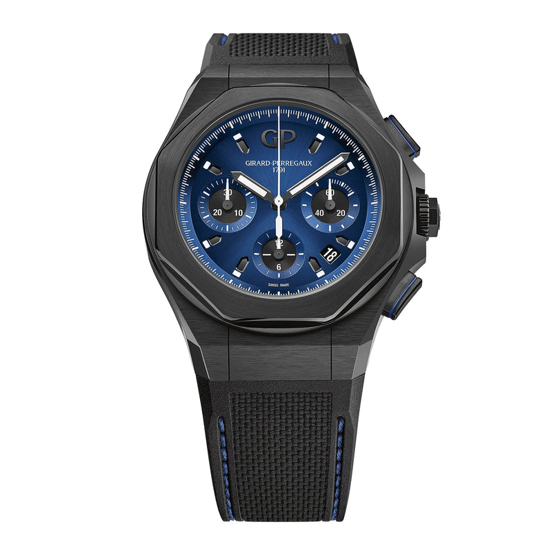 The Girard-Perregaux Laureato Absolute Chronograph features a black PVD-treated titanium case, black and blue design, GP03300 self-winding chronograph movement, three subdials, date at 4 o’clock, and a textured black strap with blue stitching.