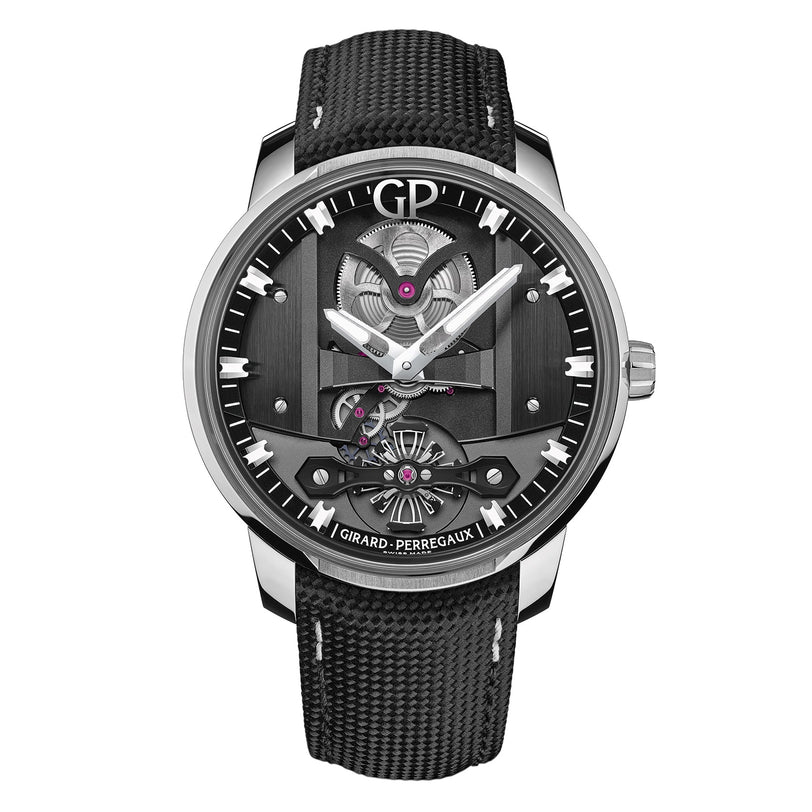 The Girard-Perregaux Free Bridge is a luxury wristwatch with a black textured strap, silver case, and exposed automatic movement on its black dial.