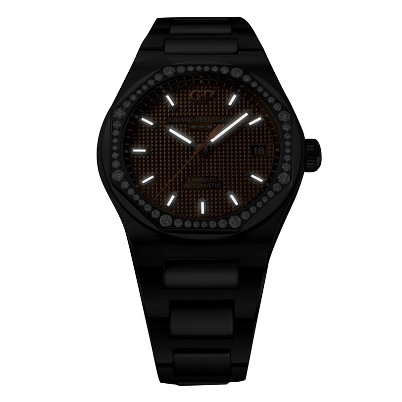 The Girard-Perregaux Laureato 38 is a black wristwatch with an octagonal bezel, textured brown dial, white hour markers, date at 3 o’clock, and a black metal band.