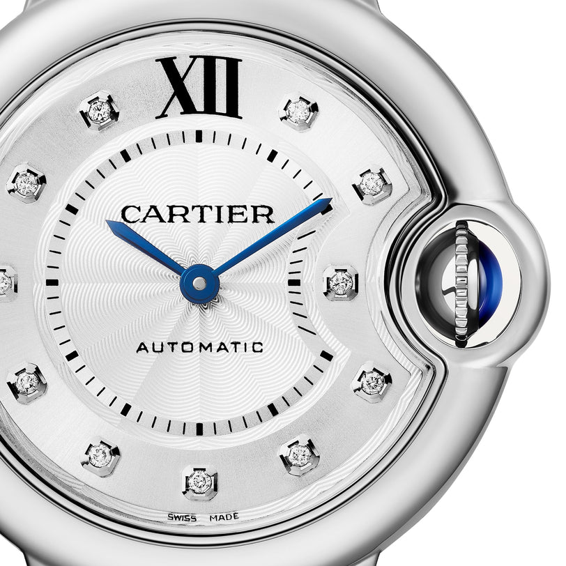 Close-up of the Ballon Bleu de Cartier watch by Cartier, showcasing blue hands, diamond hour markers, Roman numeral XII, a self-winding mechanical movement, and the signature sapphire cabochon crown.