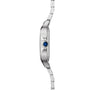Side view of the Cartier Santos de Cartier wristwatch, showcasing its square steel case, slim profile, blue gem-set crown, and metal link bracelet.