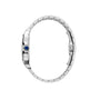 Side view of the Santos de Cartier wristwatch by Cartier, featuring a silver metal linked bracelet, blue gem-set crown, and self-winding mechanical movement.
