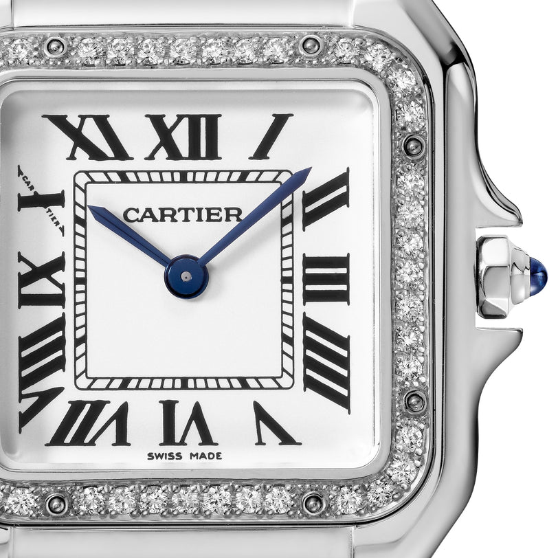 Close-up of a Cartier Panthère de Cartier watch, featuring Roman numerals, blue hands, brilliant-cut diamond bezel, silver case, and a blue cabochon crown.