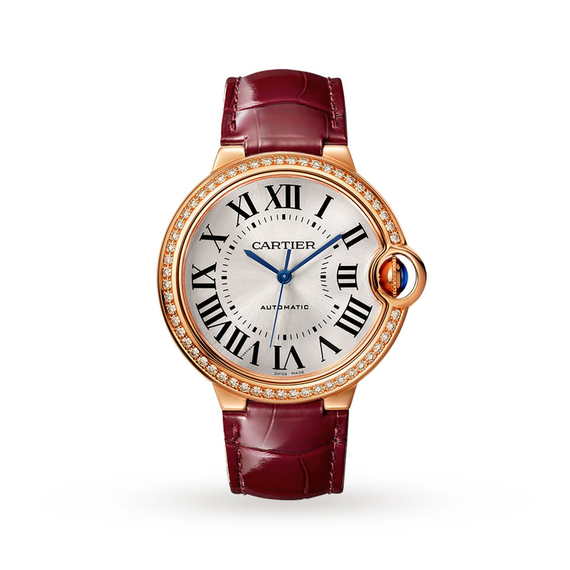 The Ballon Bleu de Cartier by Cartier features a round gold case, diamond bezel, Roman numerals, blue hands, and a vibrant red leather strap.