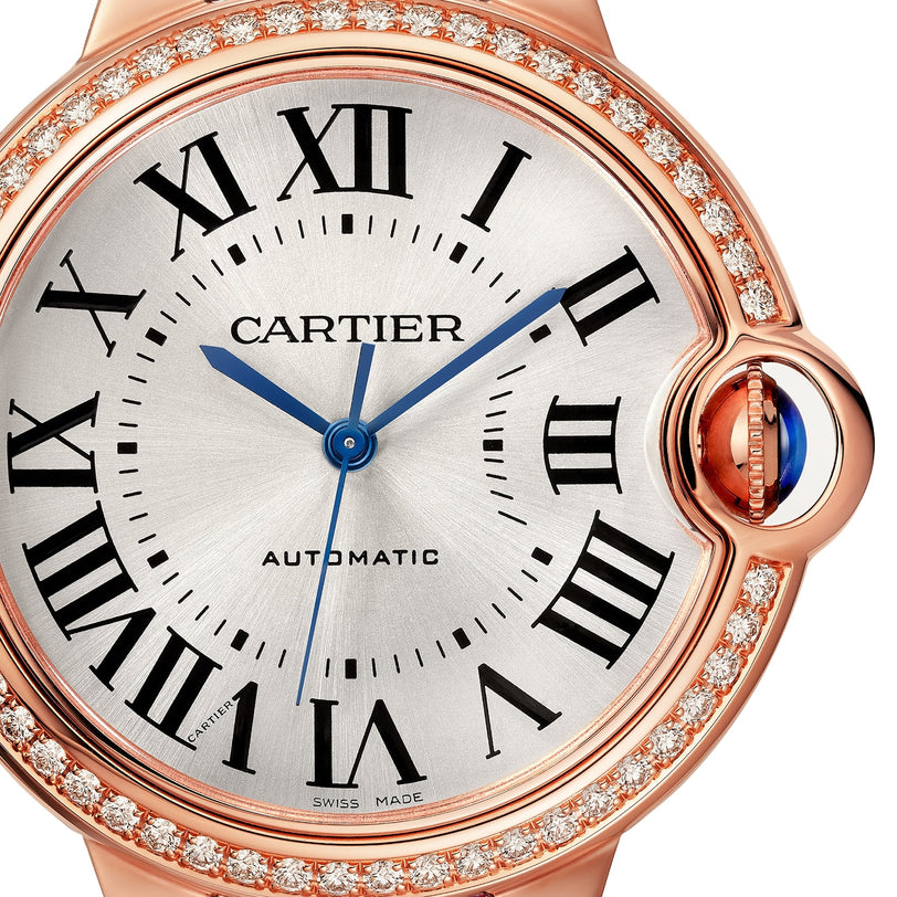 Close-up of the Ballon Bleu de Cartier watch by Cartier, featuring Roman numerals, blue hands, and a diamond bezel.