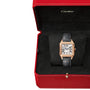 The Cartier Santos-Dumont watch features a square face, black leather strap, and 18K rose gold case, elegantly presented in a red Cartier box with gold trim.