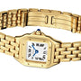 The Panthère de Cartier wristwatch by Cartier features a gold case, white dial with Roman numerals, and a blue gemstone set on the crown.