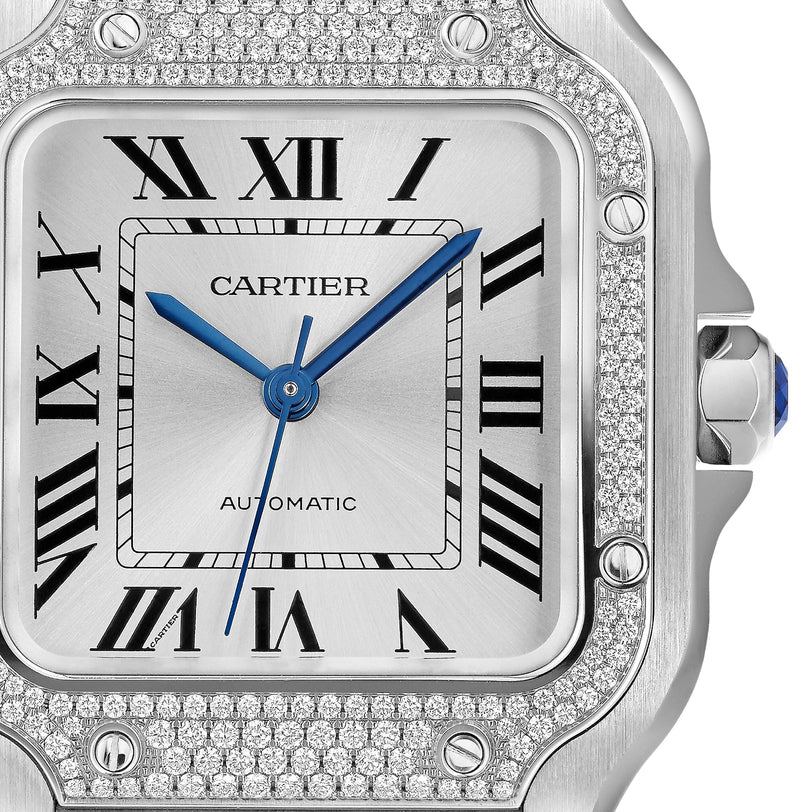 Close-up of the Cartier Santos de Cartier watch with a silver face, blue hands, Roman numeral hour markers, diamond-encrusted bezel, and AUTOMATIC above 6 oclock, highlighting its automatic movement.