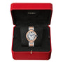 The Ballon Bleu de Cartier watch by Cartier, featuring a silver and rose gold interchangeable bracelet, is displayed in an open red Cartier box with a black interior.