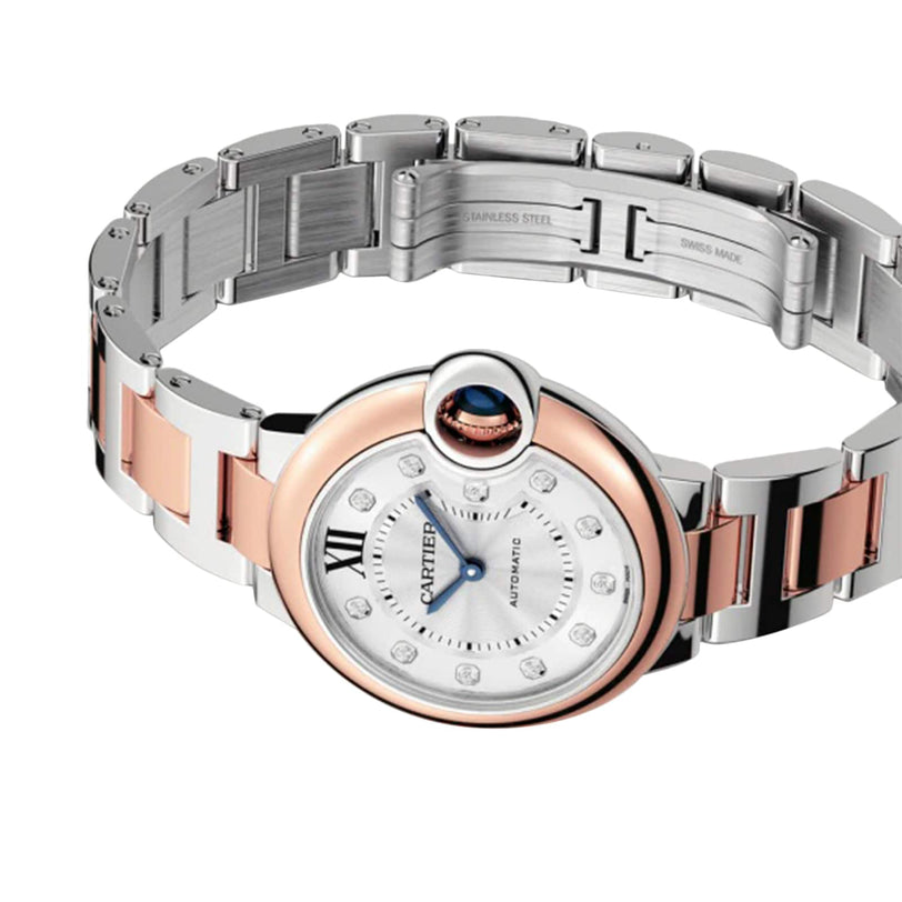 The Ballon Bleu de Cartier watch by Cartier features a round guilloché dial with Roman numerals, a stainless steel bracelet, and silver and rose gold accents, shown on a white background.