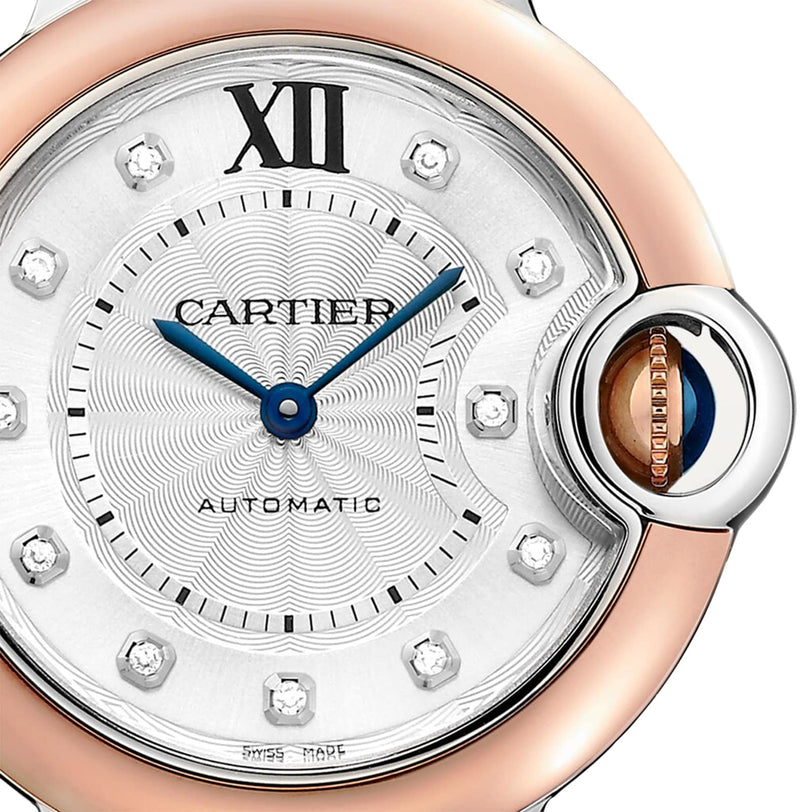 Close-up of the Ballon Bleu de Cartier watch face featuring blue hands, a guilloché dial, Roman numeral XII, diamond hour markers, and a round case with Cartiers signature crown on the right side.