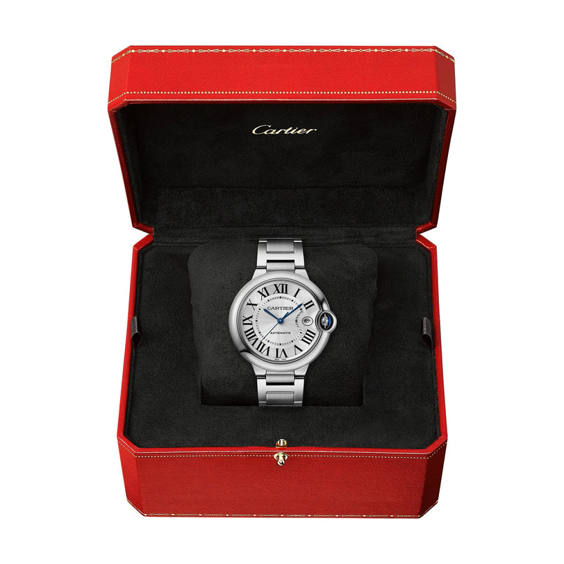 A Cartier Ballon Bleu de Cartier wristwatch with a white dial, Roman numerals, steel interchangeable bracelet, presented in an open red Cartier box with black lining.