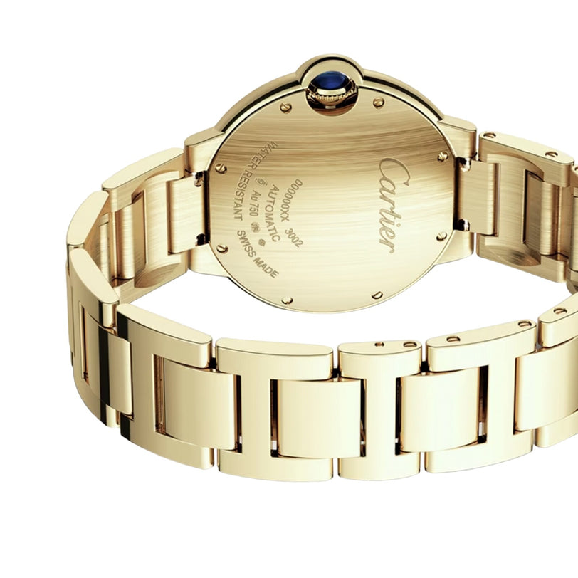 A yellow gold Cartier Ballon Bleu de Cartier wristwatch shown from the back, featuring engraved branding, specifications, and a signature blue cabochon crown.