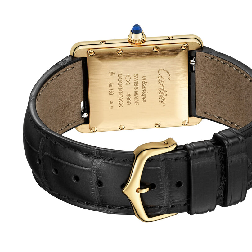 Close-up of the back of a Cartier Tank Louis Cartier watch featuring a gold case and black leather strap.