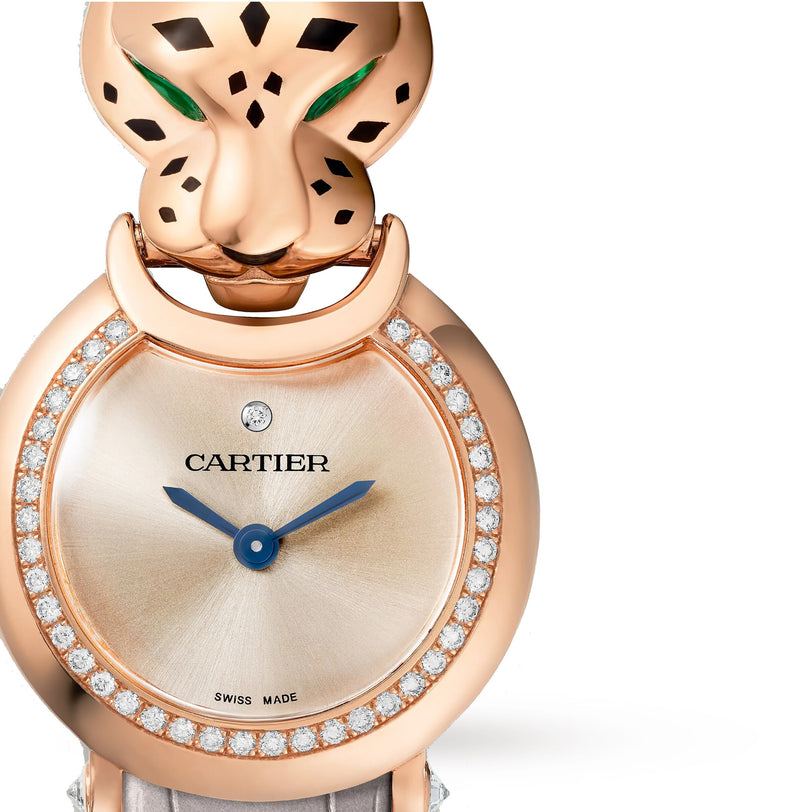 Cartiers La Panthère de Cartier watch boasts a rose gold case, diamond-set bezel, blue hands on the dial, a sculpted panther head with green eyes, and an elegant alligator leather strap.