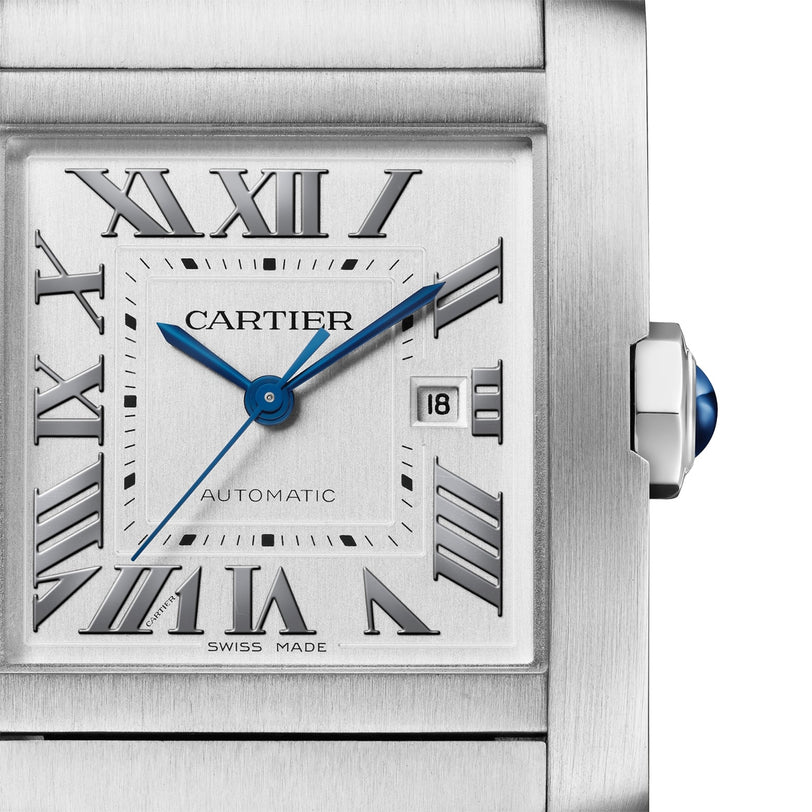 Close-up of the Cartier Tank Française, featuring a silver square face, blue hands, Roman numerals, date window at 3 o’clock, blue cabochon crown, and a sleek steel bracelet.