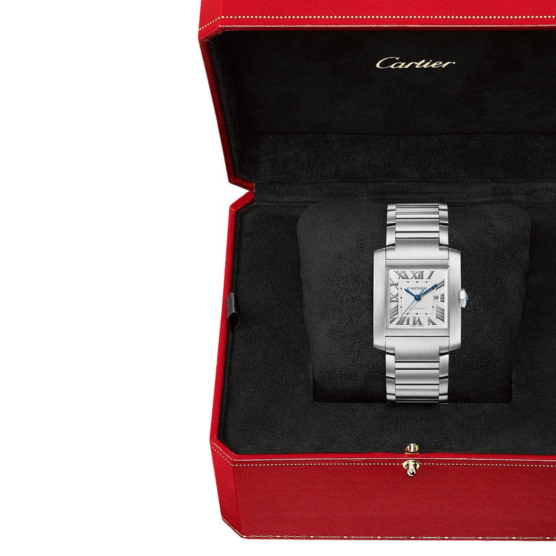A Cartier Tank Française watch with a silver-tone steel bracelet and rectangular Roman numeral face is displayed in an open red Cartier box with a black interior.