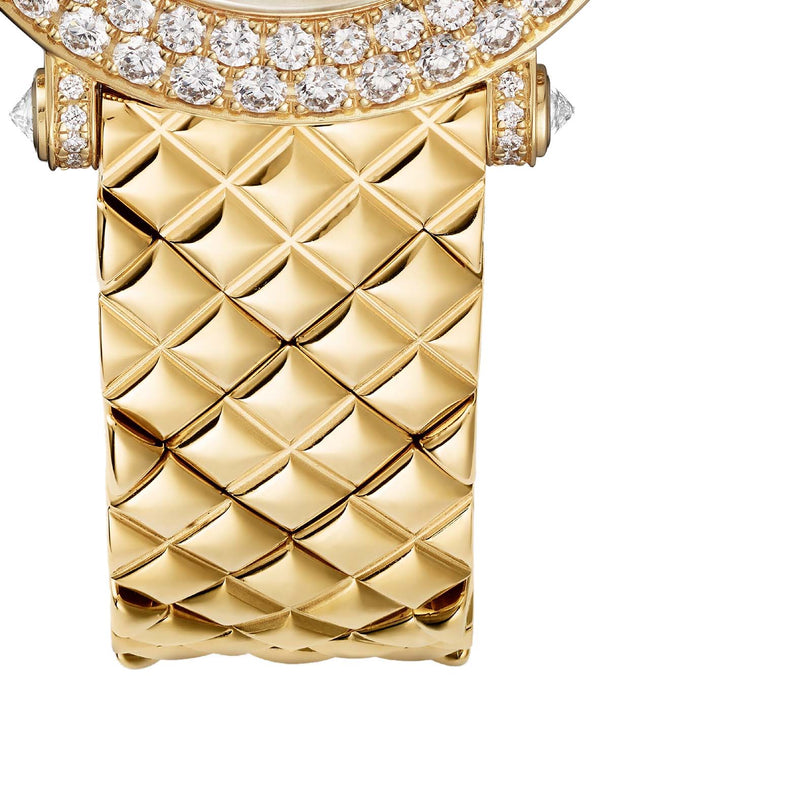 Close-up of the La Panthère de Cartier bracelet by Cartier, crafted in 18K yellow gold with a quilted pattern and a bezel set with sparkling diamonds.