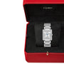 A Cartier Tank Française wristwatch, a design icon with a rectangular face and diamond accents, is displayed in an open red Cartier box lined with black fabric.
