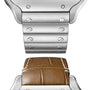 Close-up of a minimalist metal bracelet with visible screws by Cartier, displayed above a brown leather Santos de Cartier strap with white stitching.