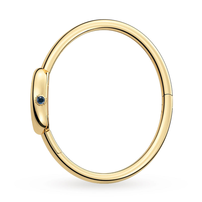 The Cartier Baignoire (Size 15) is a sleek yellow gold bangle featuring a small blue gemstone on the clasp—an elegant complement to your Cartier watch.