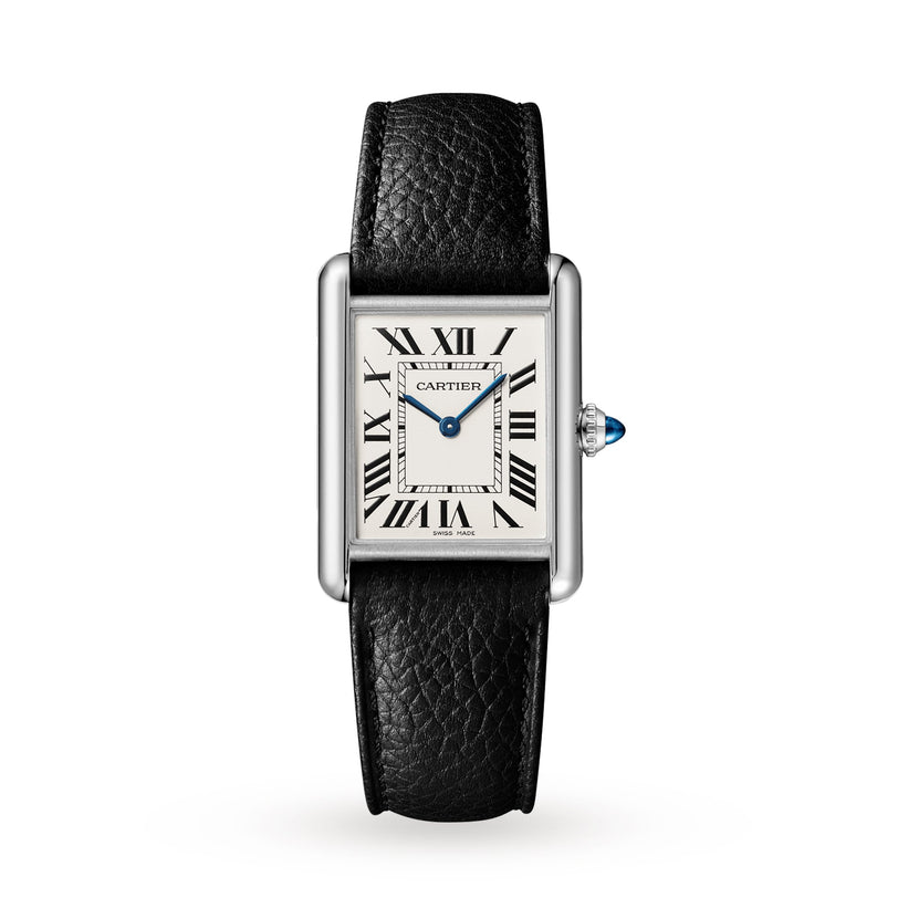 The Cartier Tank Must de Cartier watch features a rectangular white dial with black Roman numerals, blue hands, and a black leather strap. This quartz timepiece is shown on a plain white background.