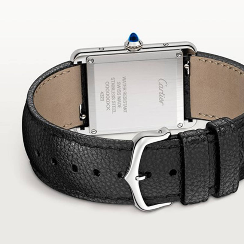 Back view of the Cartier Tank Must de Cartier watch, featuring a black leather strap, stainless steel case, engraved water-resistant details on the back, and reliable quartz movement.