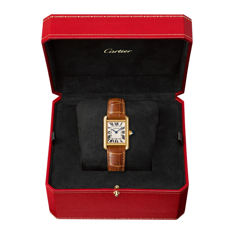The Cartier Tank Louis Cartier watch, featuring a yellow gold case and brown leather strap, is presented in an open red and black Cartier box with its crown set with the signature sapphire cabochon.
