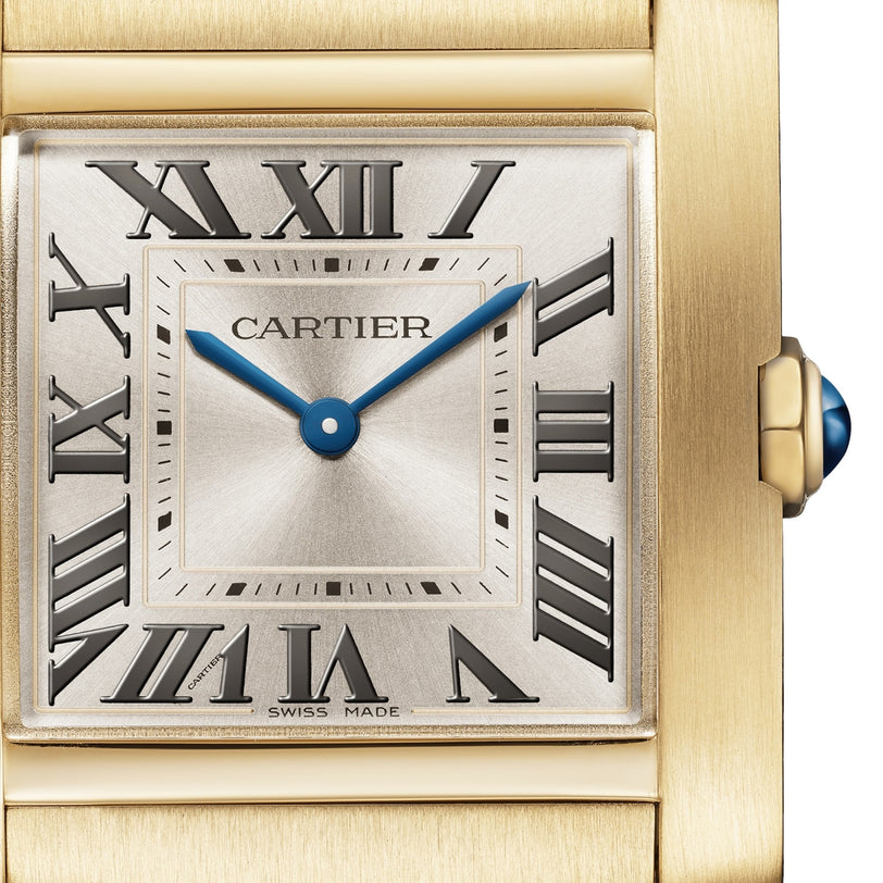 Close-up of the Cartier Tank Française watch face featuring Roman numerals, blue hands, and CARTIER and SWISS MADE labels. The yellow gold bracelet matches the crown’s signature blue cabochon detail.