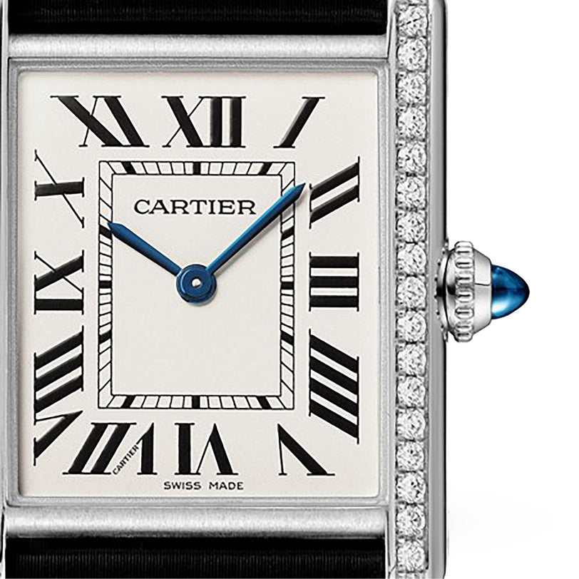 The Cartier Tank Must de Cartier features Roman numeral markers, blue hands, a diamond bezel, and a blue cabochon crown; it runs on precise quartz movement.