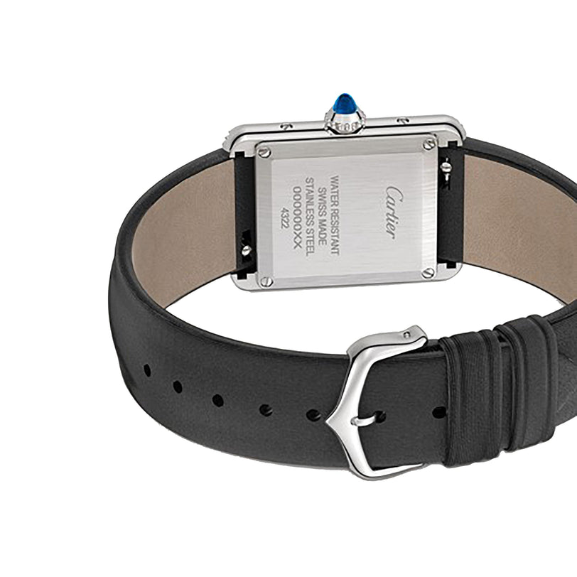 A close-up of the back of the Cartier Tank Must de Cartier wristwatch, featuring a black leather strap, water-resistant steel case, and engraved details such as serial numbers.