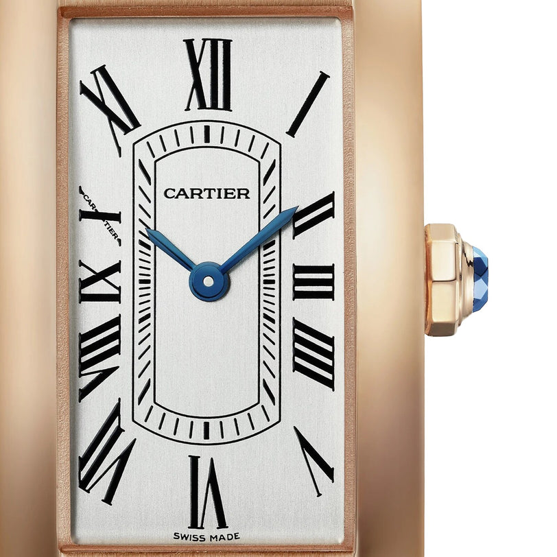 Close-up of the Cartier Tank Américaine, showcasing its rose gold case, rectangular dial with Roman numeral hour markers, blue hands, and a crown adorned with a blue cabochon.
