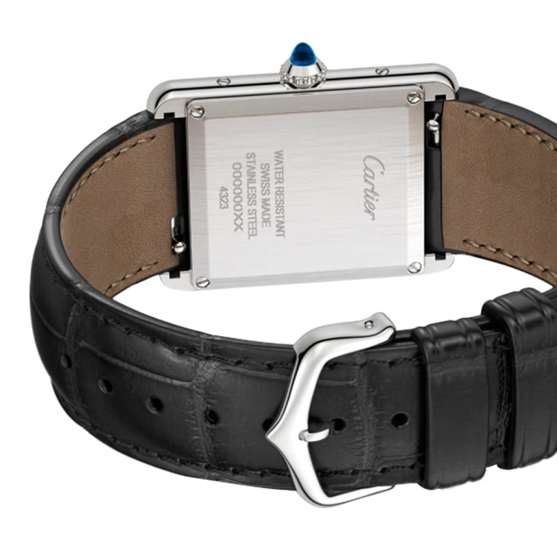Close-up of the back of a Tank Must de Cartier watch by Cartier, featuring a black alligator-skin strap, stainless steel case, and water resistance details engraved on the back.