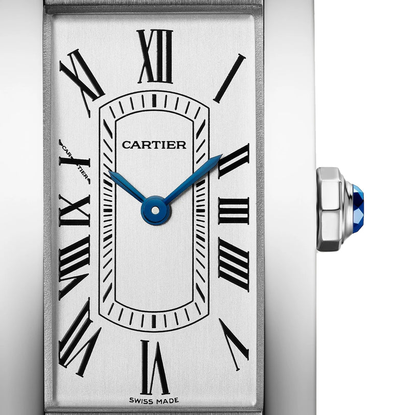 Close-up of the Cartier Tank Américaine watch face, featuring Roman numerals, blue hands, Cartier branding, and a sapphire cabochon crown—capturing the timeless elegance of this iconic Tank Américaine by Cartier.