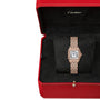 The Panthère De Cartier Watch by Cartier, featuring a rectangular face and metal band in 18K rose gold, is showcased on a black cushion within its signature red box.