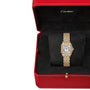 The Panthère de Cartier Watch by Cartier, featuring a rectangular face with Roman numerals and crafted in 18K yellow gold, is presented on a black cushion in a red Cartier box.