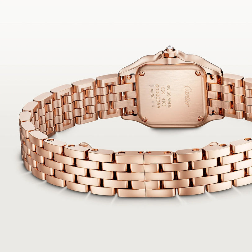 The Panthère De Cartier watch by Cartier is shown from the back, showcasing its engraved case and linked bracelet.