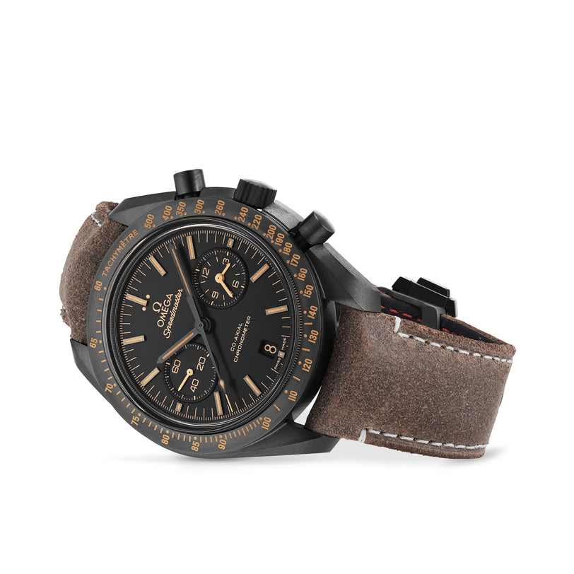 An angled view of the OMEGA Speedmaster Dark Side Of The Moon chronograph featuring a black case, brown suede strap, gold-tone accents, 9300 calibre movement, and date display.